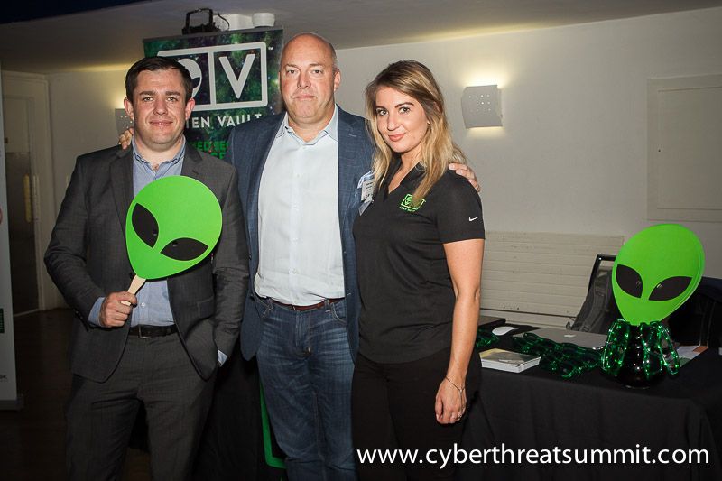 A partner in conversation with delegates at their stand during a break at an ICTTF event