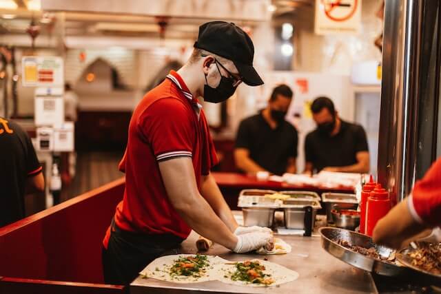 Food handler preventing contamination in kebeb shawarma - safe food handling wearing the correct uniform
