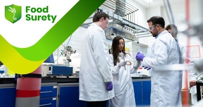 A photo of three male and one female food professionals at their food business labratory during a food safety audit conducted used as a course card for Food Surety's Advanced Auditor Training course