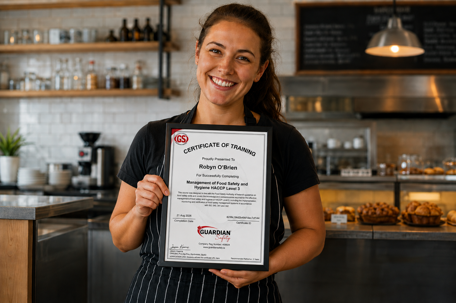 Food business employee proudly holding a framed HACCP Level 3 training certificate