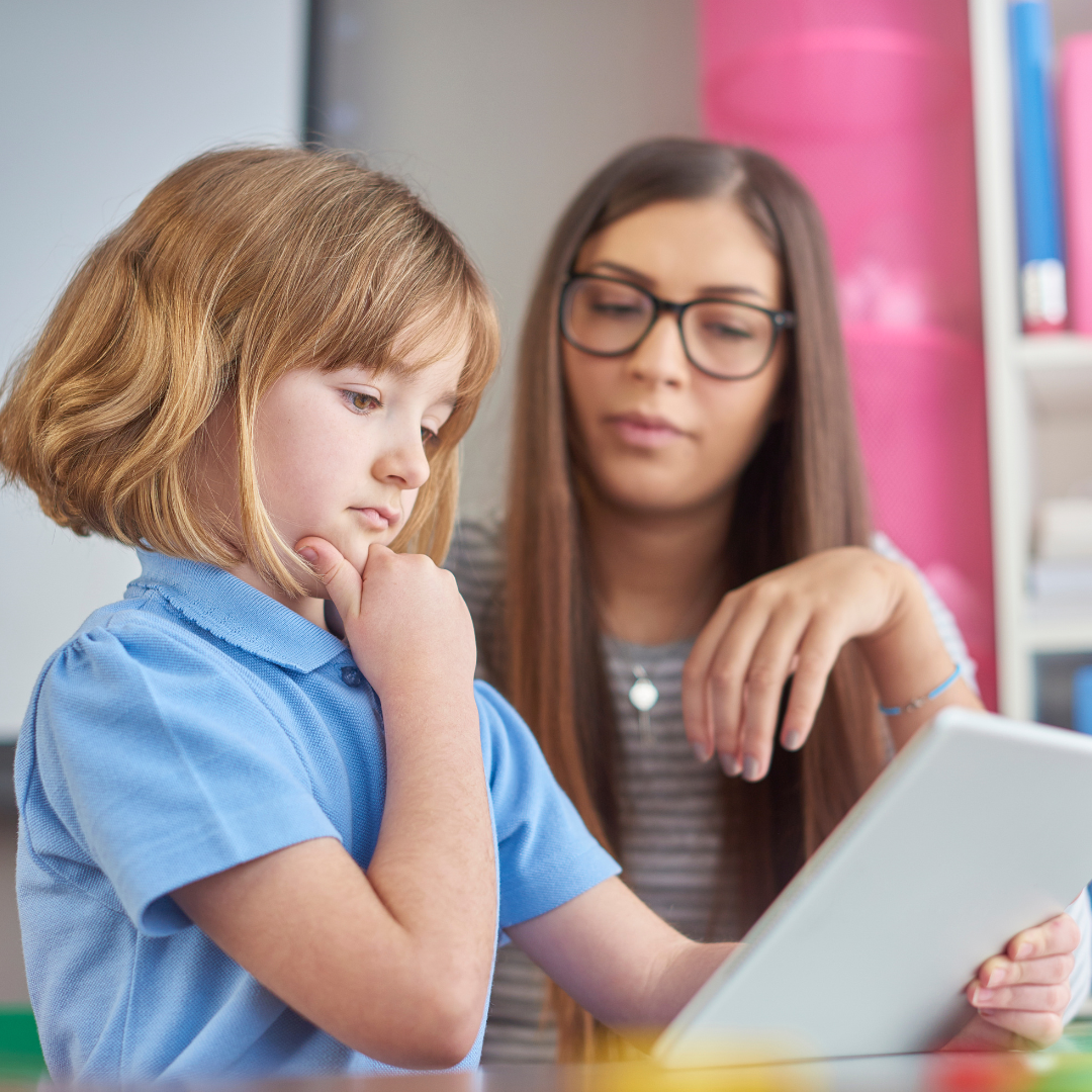 Prospero Learning Blog - What is Scaffolding in Education - Female teaching staff member helping an early years female student with an iPad
