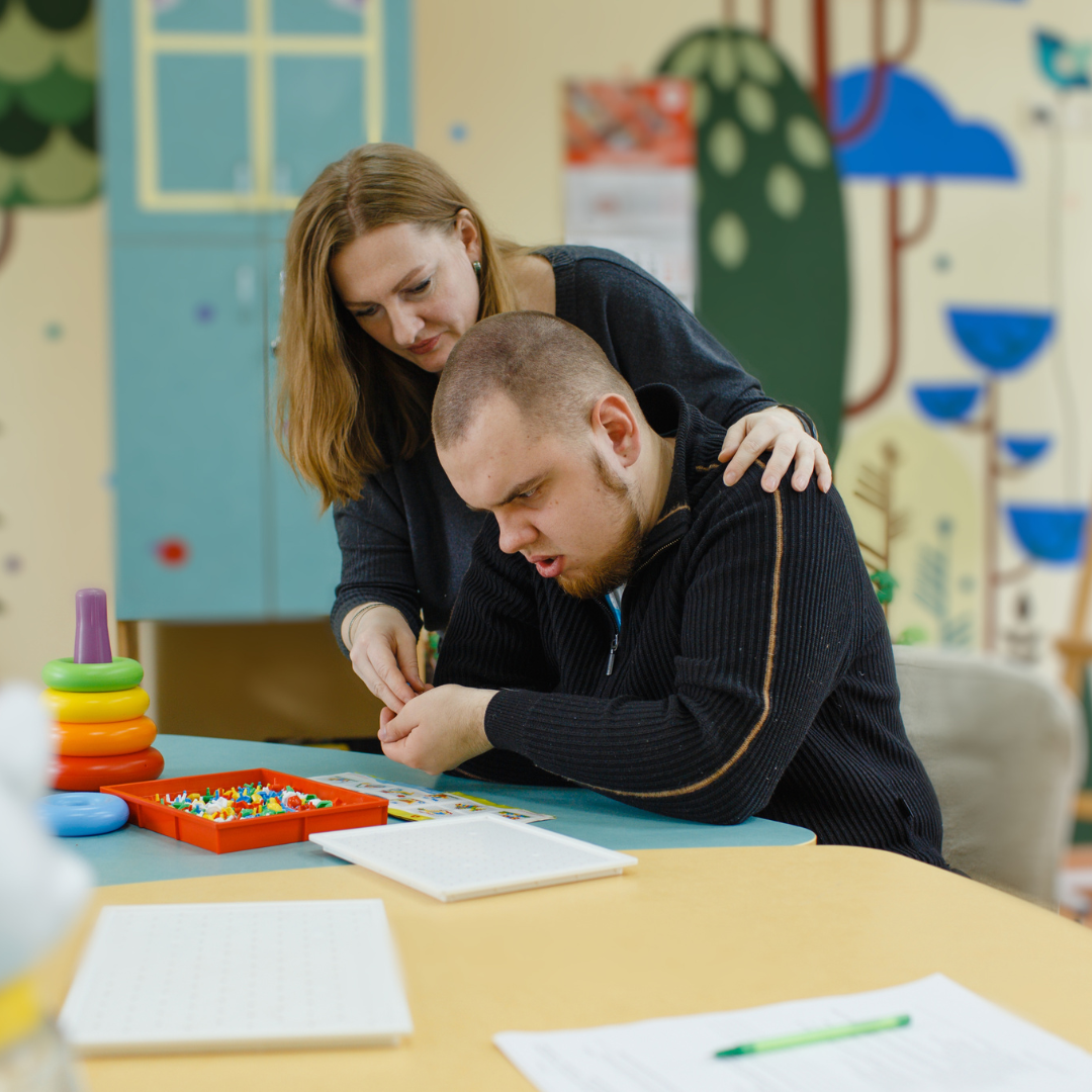 Prospero Learning Autism Blog post image - teacher supporting child with Autism