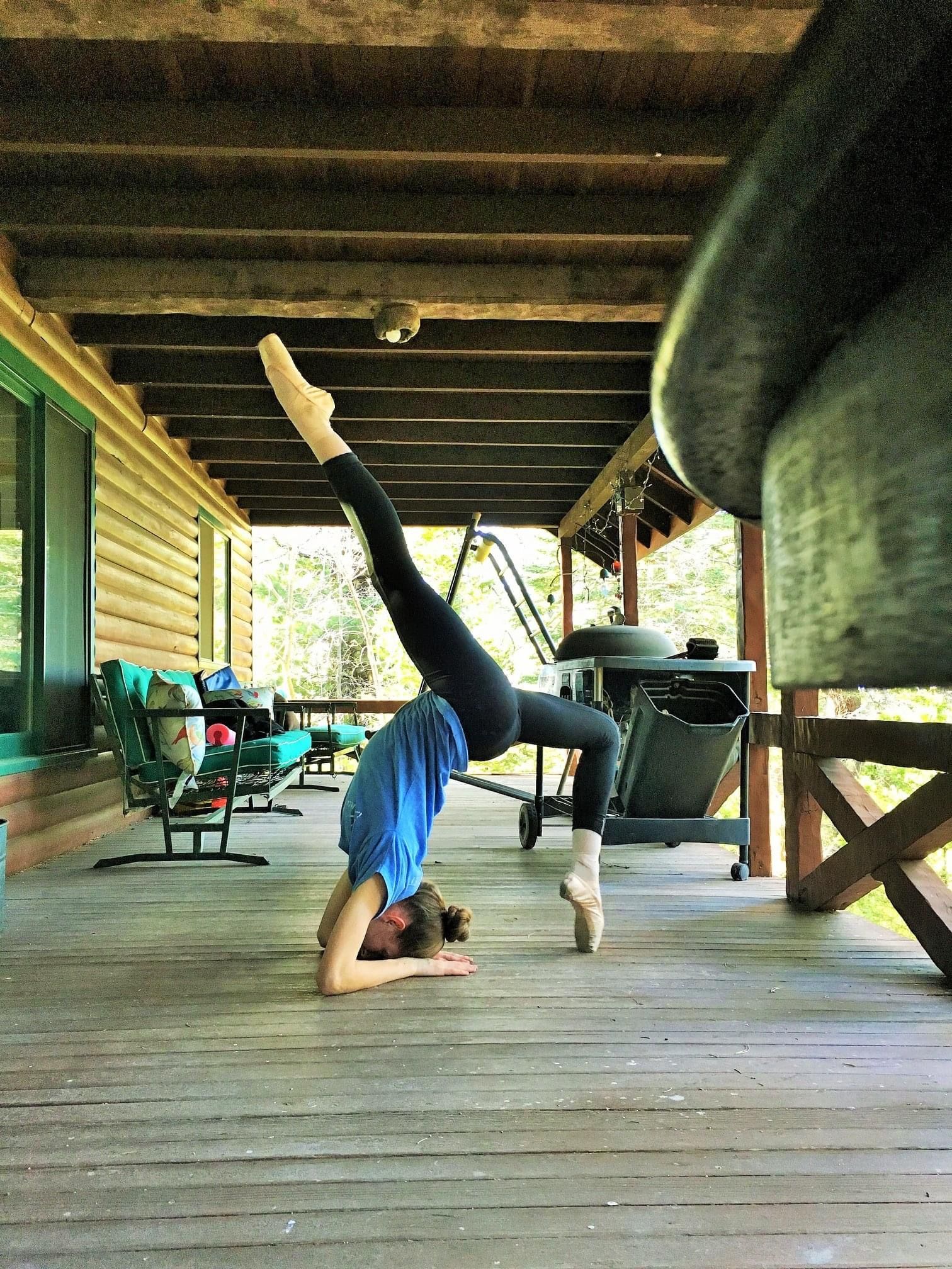 Ballerina on pointe back-bend  on elbows extending 1 leg extremely high