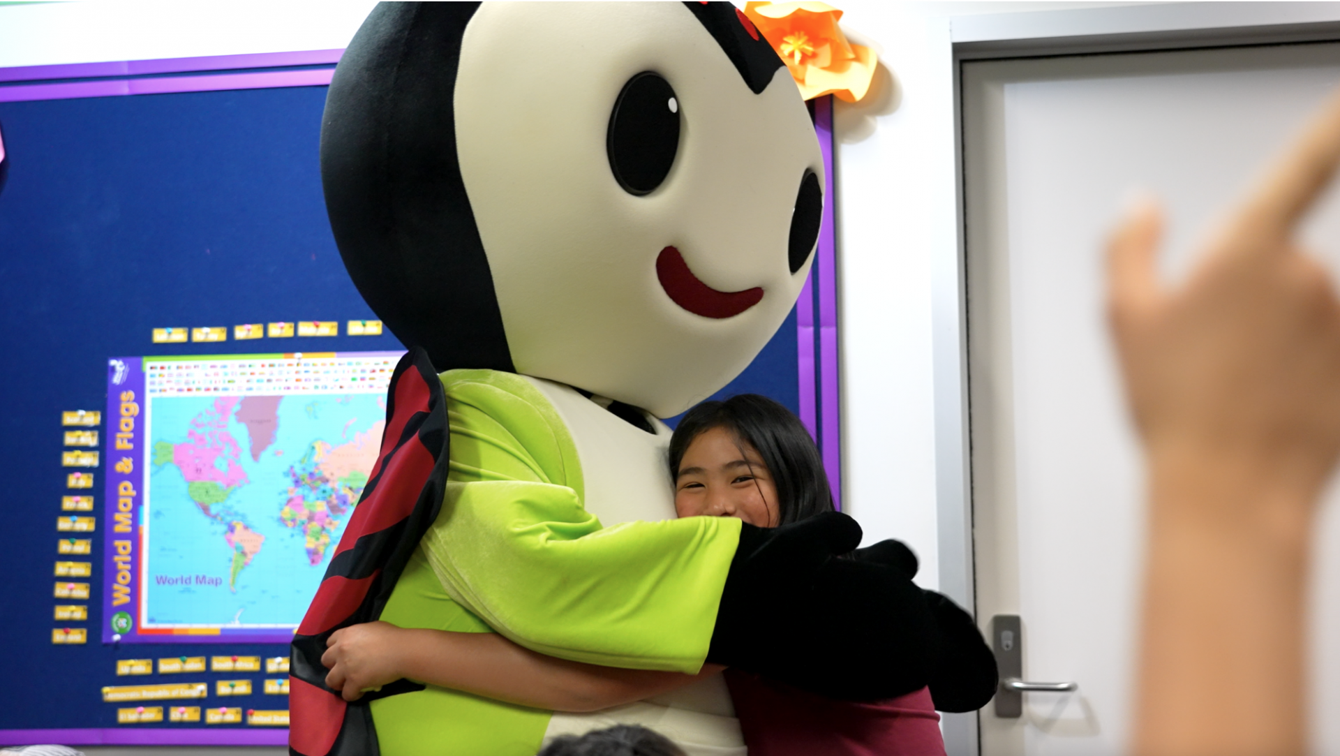 child hugging life size mascot Bug Kimochis Character 