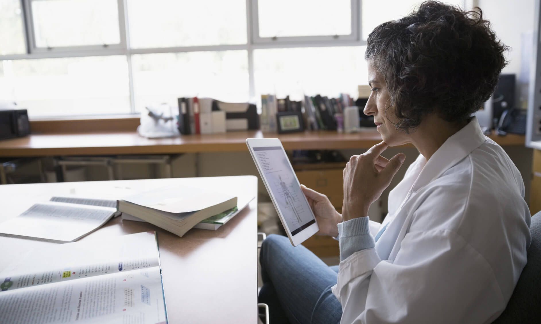 a teacher using a tablet to correct work at school
