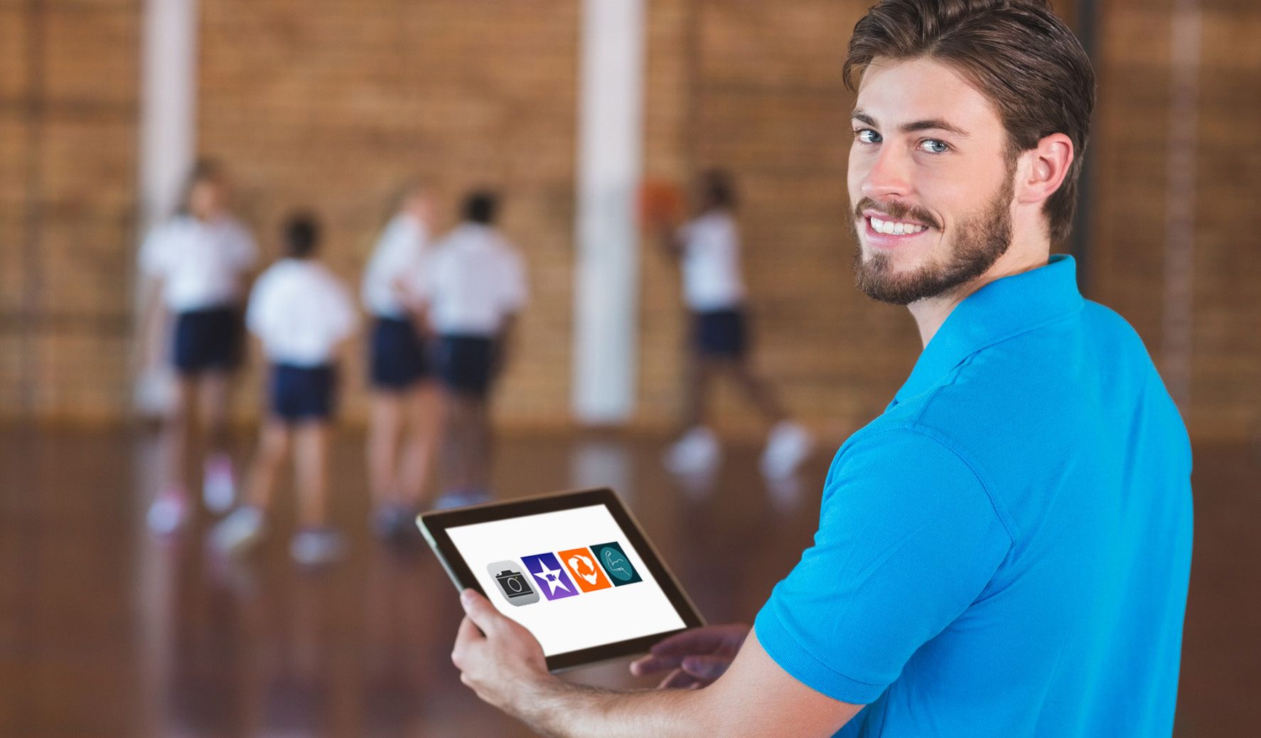 a student recording another student during PE class A PE teacher with and iPad showing PE apps