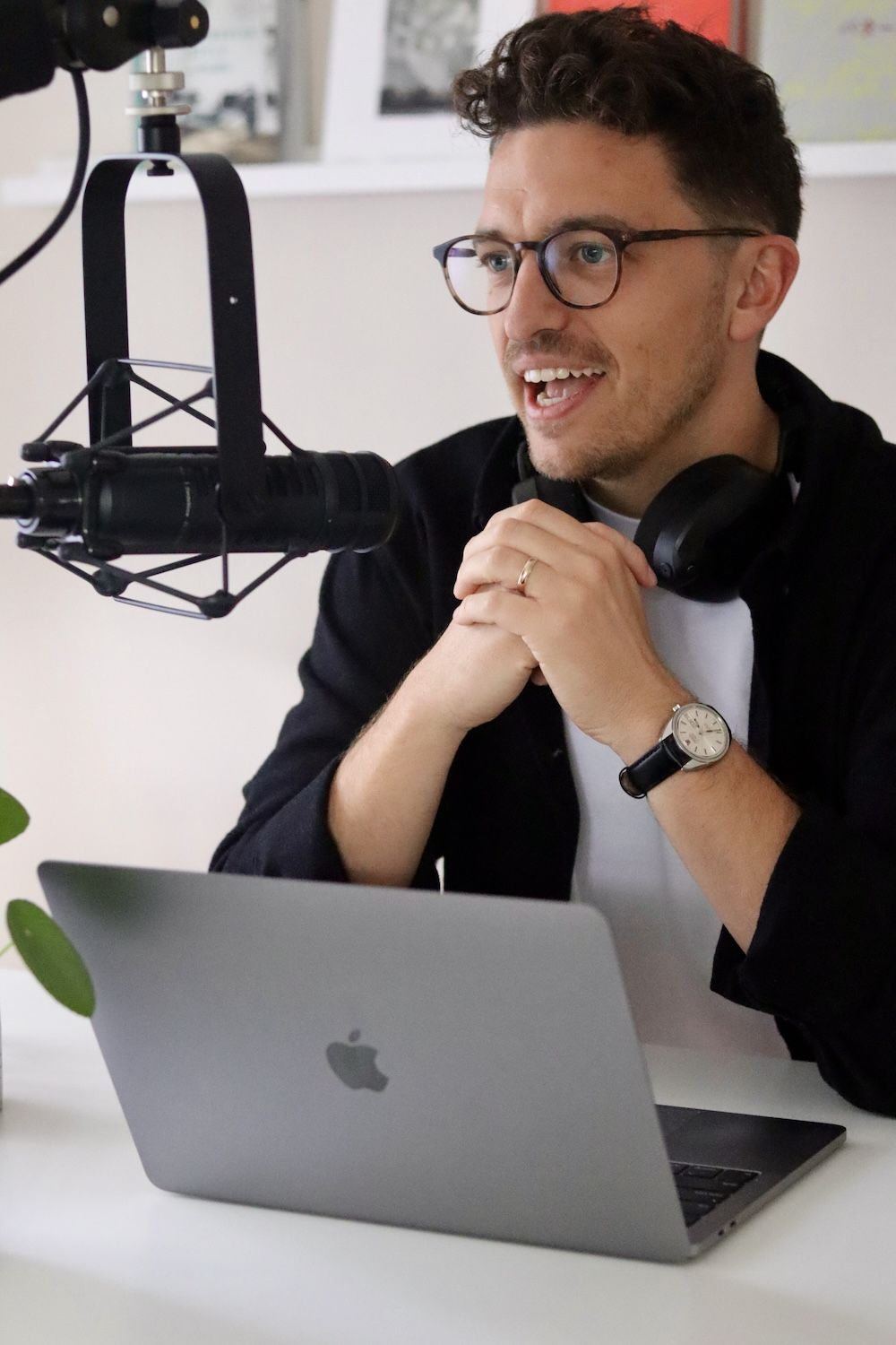 Charlie speaking into a microphone at his laptop