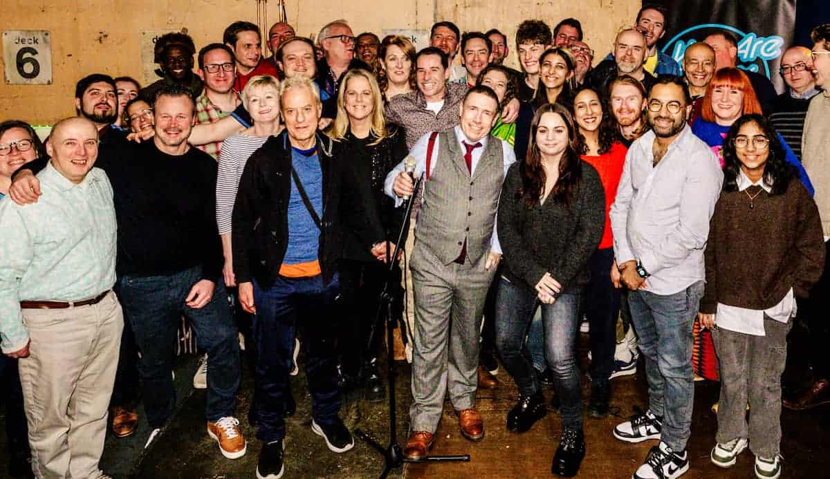 Team photo of people gathered for an away day event and smiling to the camera and looking happy as a very mixed group