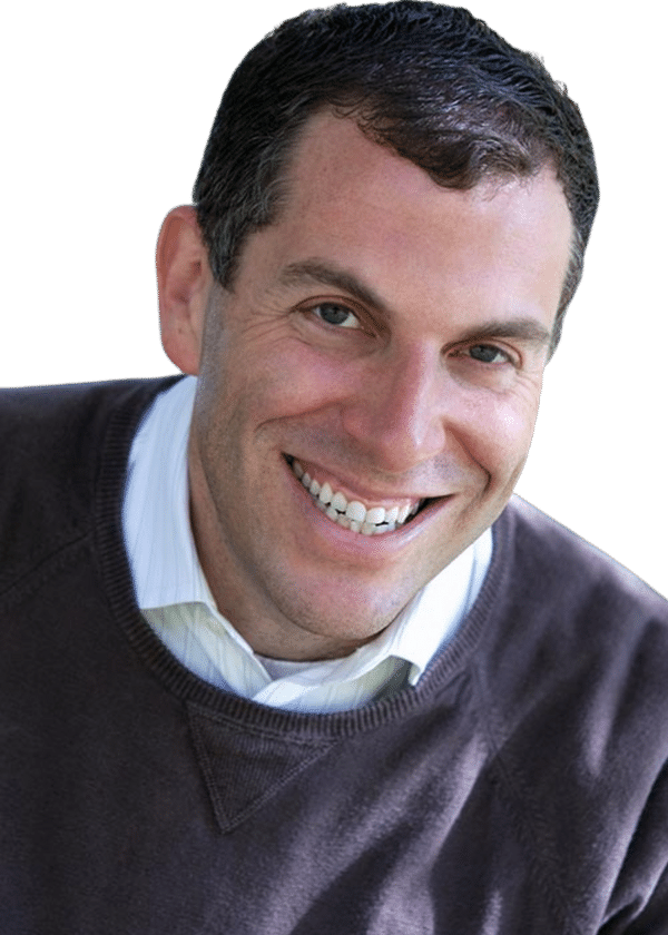 Ross Guberman smiling in a brown sweater and collared shirt
