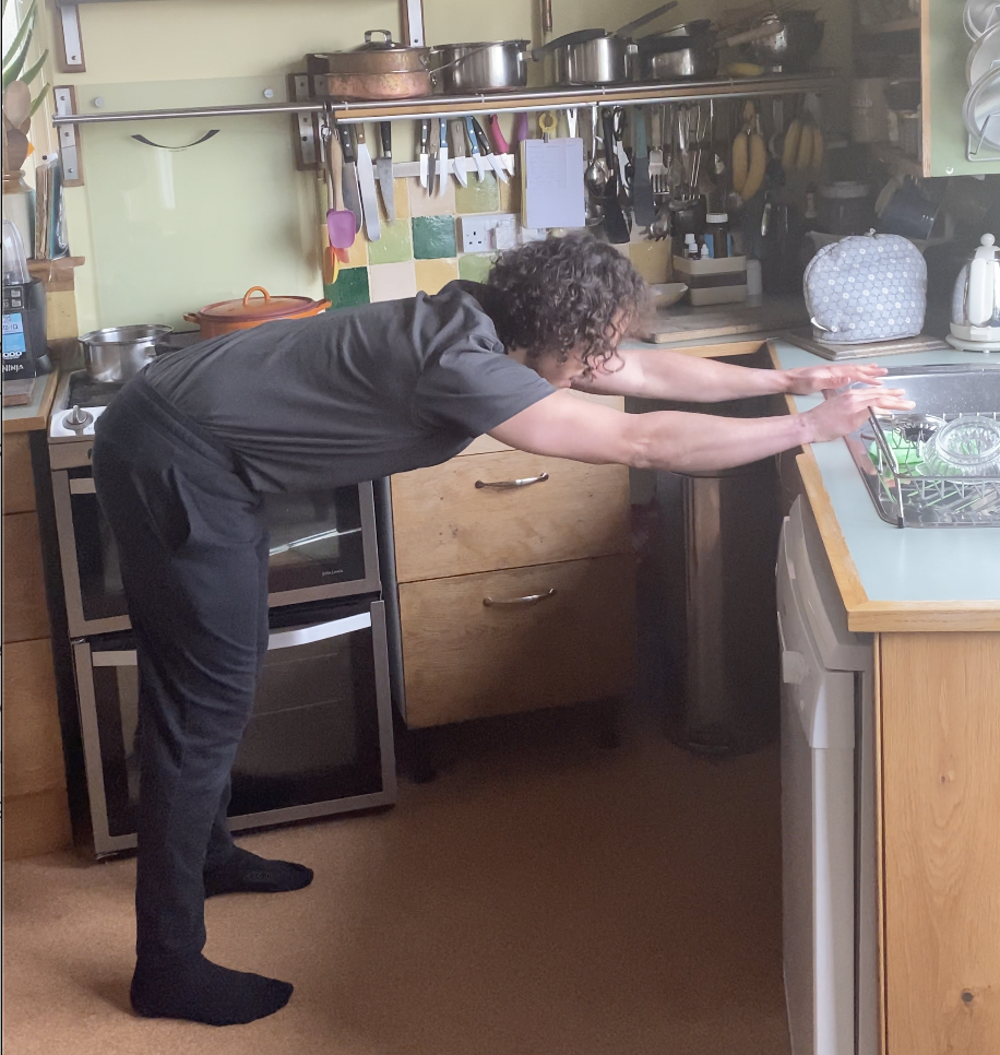 Man doing stretch on kitchen counter
